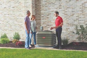 HVAC technician helping homeowners