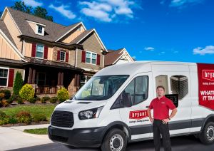 HVAC technician in front of company truck